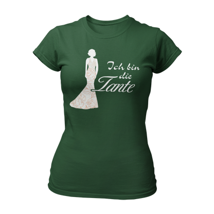 Damen T-Shirt mit der Aufschrift 'Ich bin die Tante' aus der Druckideen-Reihe 'Wer bin ich?'. Das Shirt zeigt eine stilisierte Tante in einem langen, eleganten Abendkleid und gibt einen ersten Eindruck von ihrem Hochzeitsoutfit. Teil einer Reihe, die auch die Designs 'Ich bin die Braut', 'Ich bin die Trauzeugin' und 'Ich bin die Schwester' umfasst. Dieses Shirt fördert das Kennenlernen und sorgt für Spaß beim Junggesellenabschied, während es Gespräche anregt